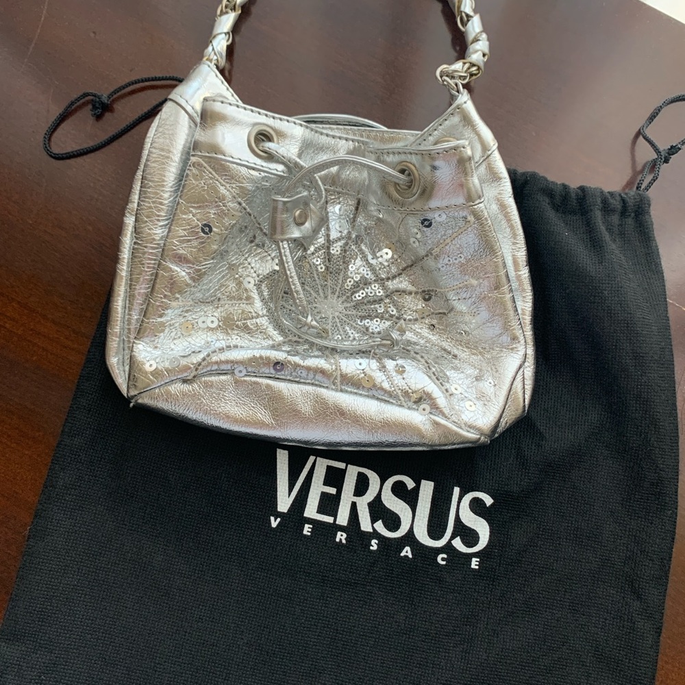 SOLD. 
Small silver leather Versace purse.